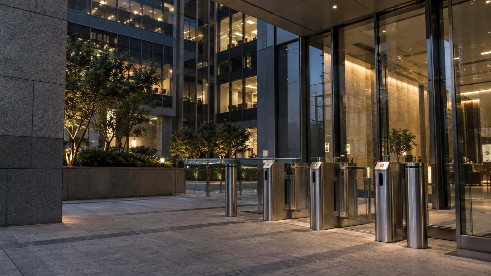 Office courtyard and stainless-steel access gates at dusk